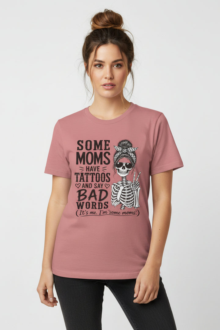 A dusty rose short-sleeve t-shirt with a graphic print featuring a skeleton and the text &