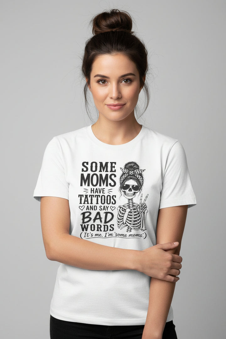 A white short-sleeve crewneck t-shirt featuring a black graphic print of a skeleton woman with a bandana and sunglasses, next to the text &