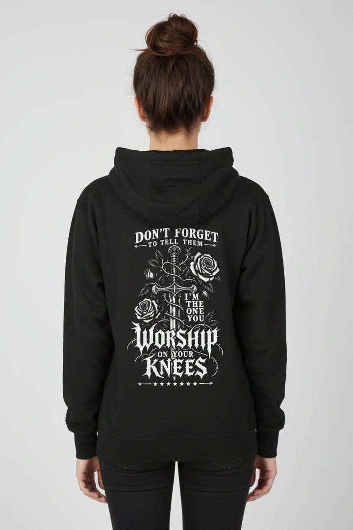 A black pullover hoodie shown from the back, featuring a white graphic print with roses, a sword, and the text &
