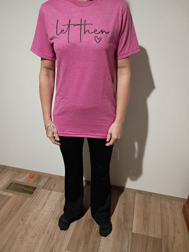 Let Them graphic tee shown in berry pink, front view worn